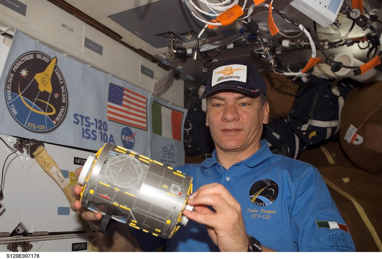 S120-E-007178 (29 Oct. 2007) --- European Space Agency (ESA) astronaut Paolo Nespoli, STS-120 mission specialist, holds a model of the Harmony node on the middeck of Space Shuttle Discovery while docked with the International Space Station.