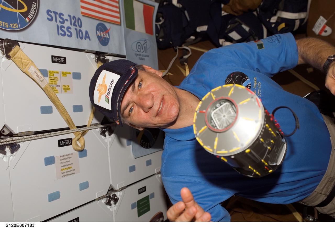 S120-E-007183 (29 Oct. 2007) --- A model of the Harmony node floats freely near European Space Agency (ESA) astronaut Paolo Nespoli, STS-120 mission specialist, on the middeck of Space Shuttle Discovery while docked with the International Space Station.