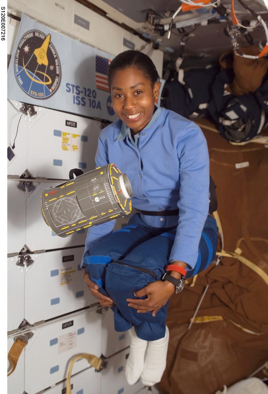 S120-E-007216 (29 Oct. 2007) --- Astronaut Stephanie Wilson, STS-120 mission specialist, and a model of the Harmony node float freely on the middeck of Space Shuttle Discovery while docked with the International Space Station.