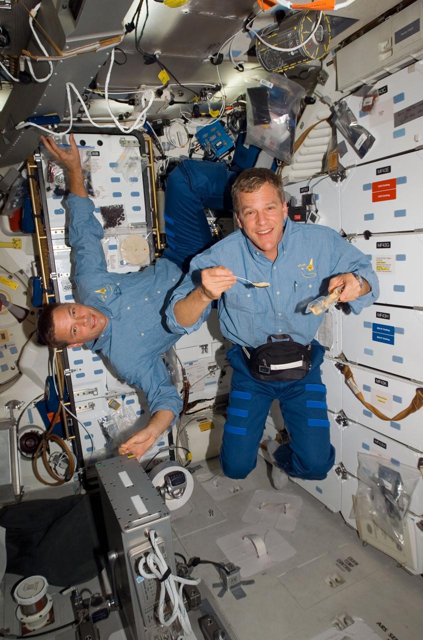 S120-E-007340 (29 Oct. 2007) --- Astronauts Doug Wheelock (left) and Scott Parazynski, both STS-120 mission specialists, float near the galley on the middeck of Space Shuttle Discovery while docked with the International Space Station.