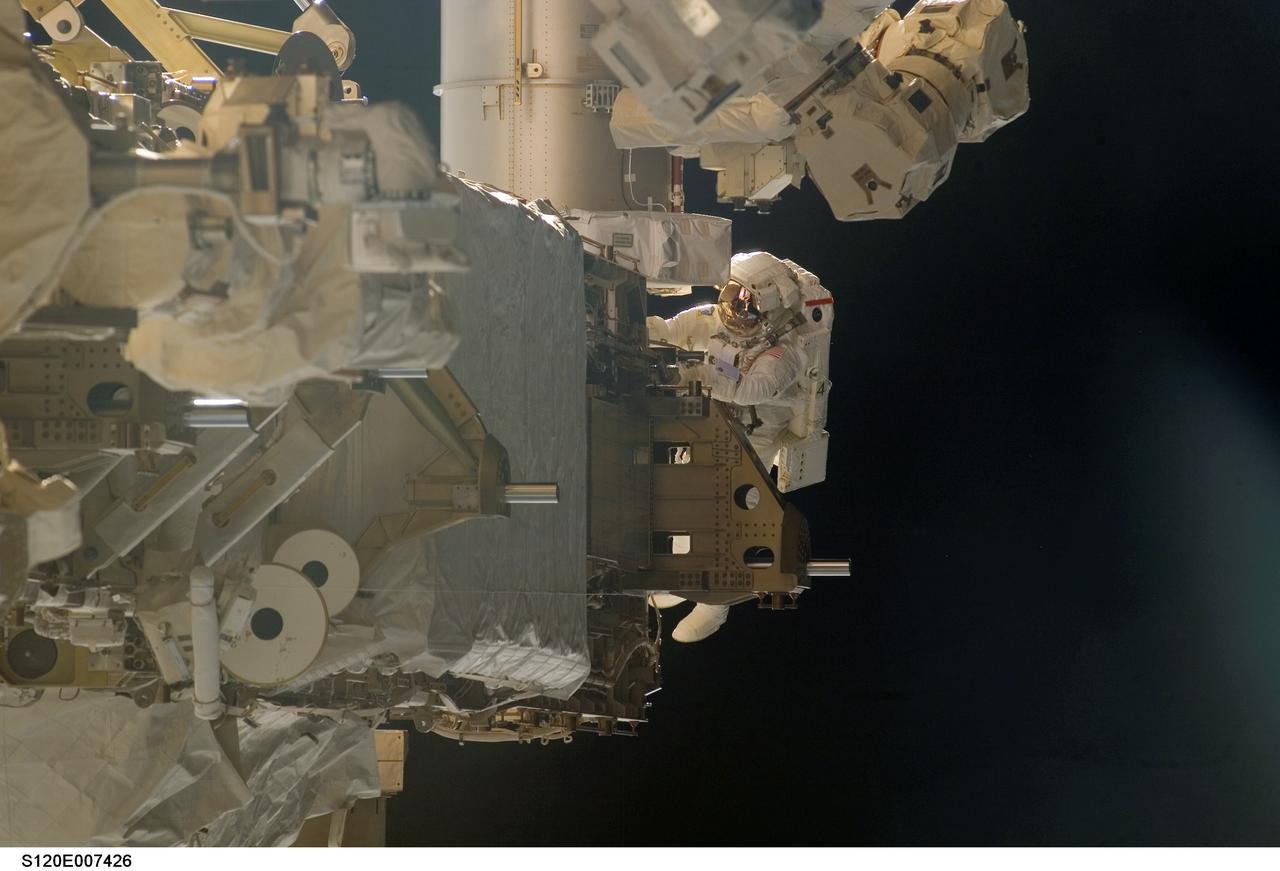 S120-E-007426 (30 Oct. 2007) --- Astronaut Scott Parazynski, STS-120 mission specialist, participates in the third scheduled session of extravehicular activity (EVA) as construction continues on the International Space Station. During the 7-hour, 8-minute spacewalk Parazynski and astronaut Doug Wheelock (out of frame), mission specialist, installed the P6 truss segment with its set of solar arrays to its permanent home, installed a spare main bus switching unit on a stowage platform, and performed a few get-ahead tasks. Also, Parazynski inspected the port Solar Alpha Rotary Joint (SARJ) to gather comparison data for the starboard rotary joint.