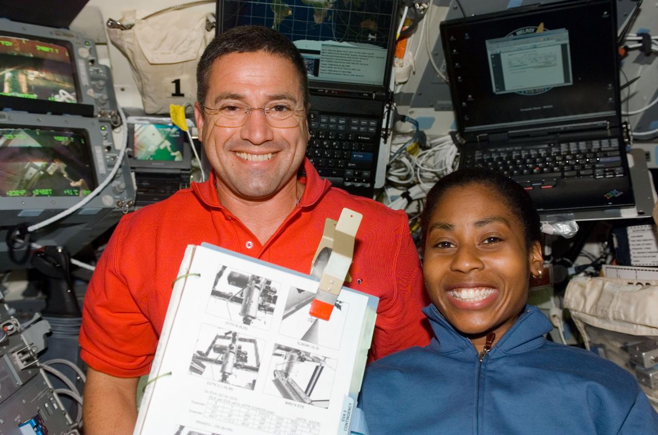 S120-E-007552 (30 Oct. 2007) --- Astronauts George Zamka and Stephanie Wilson, STS-120 pilot and mission specialist, respectively, take a moment to pose for a photo on the flight deck of Space Shuttle Discovery during flight day eight activities while docked with the International Space Station.