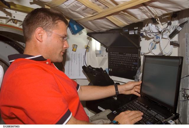 NASA image: Wheelock with computer on Discovery middeck
