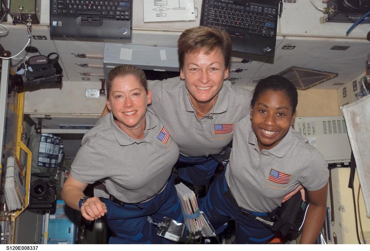 S120-E-008337 (4 Nov. 2007) --- Astronauts Pam Melroy (left), STS-120 commander; Peggy Whitson, Expedition 16 commander; and Stephanie Wilson, STS-120 mission specialist, pose for a photo in the Zvezda Service Module of the International Space Station while Space Shuttle Discovery is docked with the station.