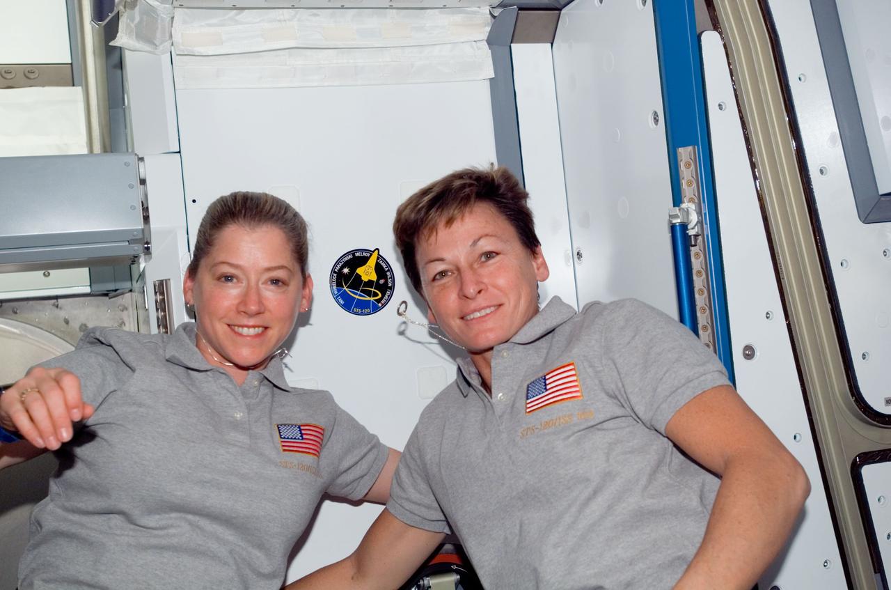 S120-E-008356 (4 Nov. 2007) --- Astronauts Pam Melroy (left), STS-120 commander; and Peggy Whitson, Expedition 16 commander, pose for a photo after placing the STS-120 crew patch in the Harmony node -- newest addition to the International Space Station -- while Space Shuttle Discovery is docked with the station.