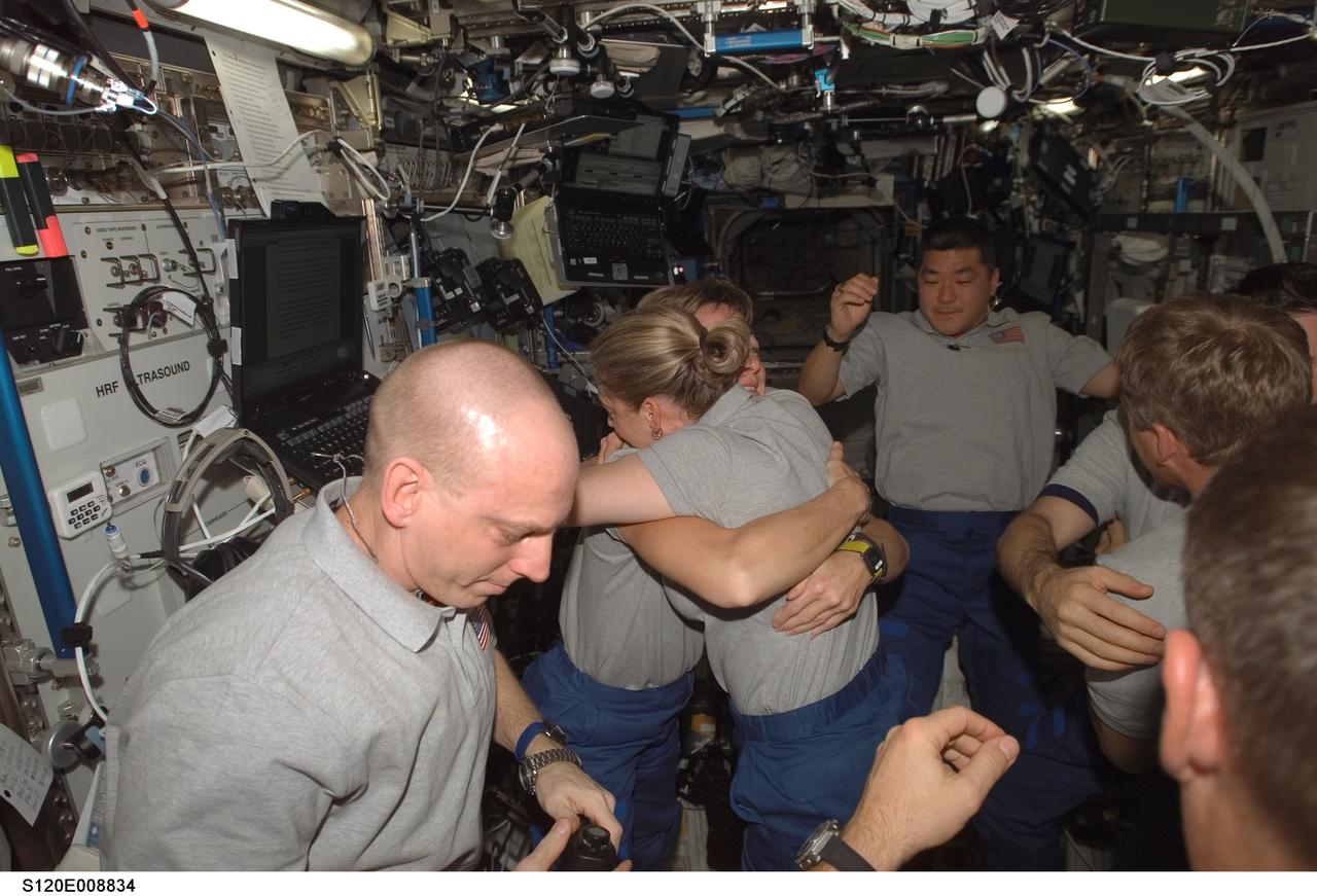 S120-E-008834 (4 Nov. 2007) --- The STS-120 and Expedition 16 crewmembers gather for a farewell ceremony in the Destiny laboratory of the International Space Station (ISS). Pictured hugging are astronauts Pam Melroy (right center), STS-120 commander; and Peggy Whitson, Expedition 16 commander. Also pictured are astronauts Clay Anderson (foreground), STS-120 mission specialist; Daniel Tani (background), ISS flight engineer; Scott Parazynski, mission specialist; and cosmonaut Yuri I. Malenchenko, ISS flight engineer representing Russia's Federal Space Agency. Hatches were closed between the station and Space Shuttle Discovery at 2:03 p.m. (CST) on Nov. 4.