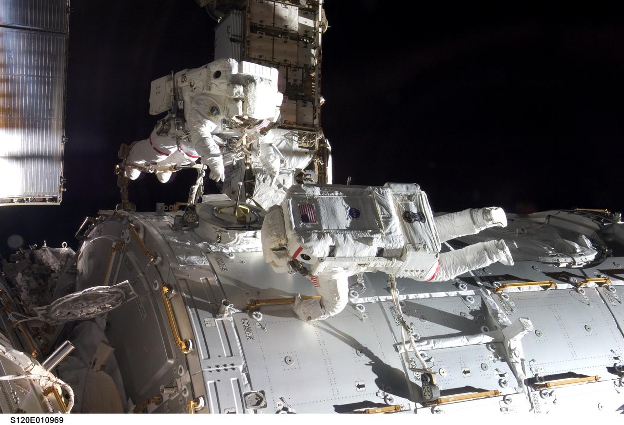 S120-E-010969 (28 Oct. 2007) --- Astronauts Daniel Tani (left), Expedition 16 flight engineer, and Scott Parazynski, STS-120 mission specialist, participate in the second scheduled session of extravehicular activity (EVA) as construction continues on the International Space Station. During the 6-hour, 33-minute spacewalk Tani and Parazynski outfitted the Harmony module, mated the power and data grapple fixture and reconfigured connectors on the starboard 1 (S1) truss that will allow the radiator on S1 to be deployed from the ground later. Also the spacewalkers worked in tandem to disconnect cables from the P6 truss, allowing it to be removed from the Z1 truss. Tani also visually inspected the station's starboard Solar Alpha Rotary Joint (SARJ) and gathered samples of "shavings" he found under the joint's multi-layer insulation covers.
