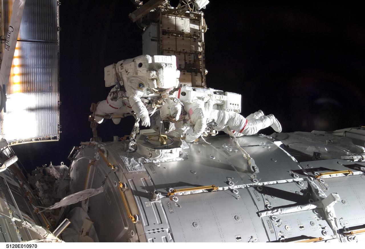 S120-E-010970 (28 Oct. 2007) --- Astronauts Daniel Tani (left), Expedition 16 flight engineer, and Scott Parazynski, STS-120 mission specialist, participate in the second scheduled session of extravehicular activity (EVA) as construction continues on the International Space Station. During the 6-hour, 33-minute spacewalk Tani and Parazynski outfitted the Harmony module, mated the power and data grapple fixture and reconfigured connectors on the starboard 1 (S1) truss that will allow the radiator on S1 to be deployed from the ground later. Also the spacewalkers worked in tandem to disconnect cables from the P6 truss, allowing it to be removed from the Z1 truss. Tani also visually inspected the station's starboard Solar Alpha Rotary Joint (SARJ) and gathered samples of "shavings" he found under the joint's multi-layer insulation covers.