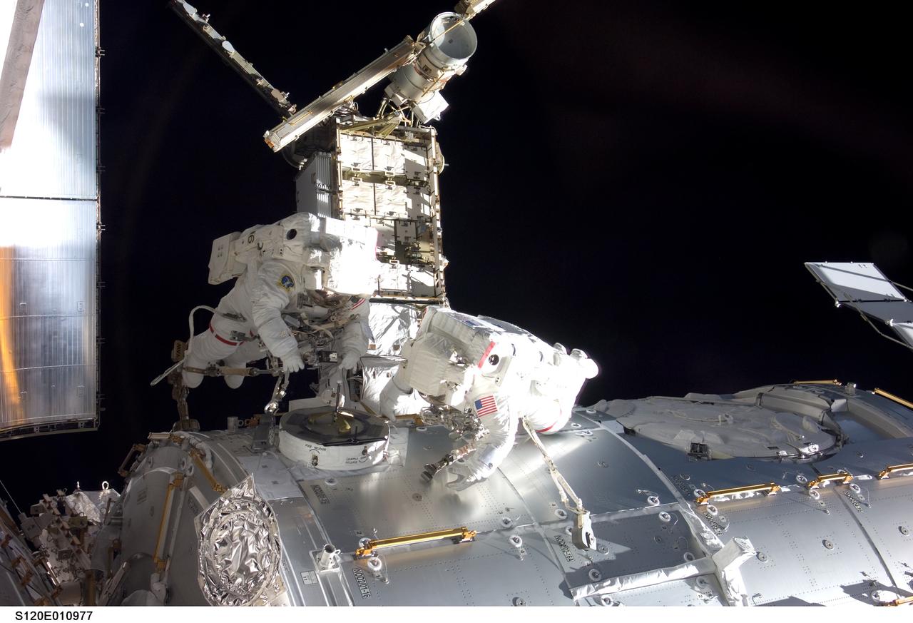 S120-E-010977 (28 Oct. 2007) --- Astronauts Daniel Tani (left), Expedition 16 flight engineer, and Scott Parazynski, STS-120 mission specialist, participate in the second scheduled session of extravehicular activity (EVA) as construction continues on the International Space Station. During the 6-hour, 33-minute spacewalk Tani and Parazynski outfitted the Harmony module, mated the power and data grapple fixture and reconfigured connectors on the starboard 1 (S1) truss that will allow the radiator on S1 to be deployed from the ground later. Also the spacewalkers worked in tandem to disconnect cables from the P6 truss, allowing it to be removed from the Z1 truss. Tani also visually inspected the station's starboard Solar Alpha Rotary Joint (SARJ) and gathered samples of "shavings" he found under the joint's multi-layer insulation covers.