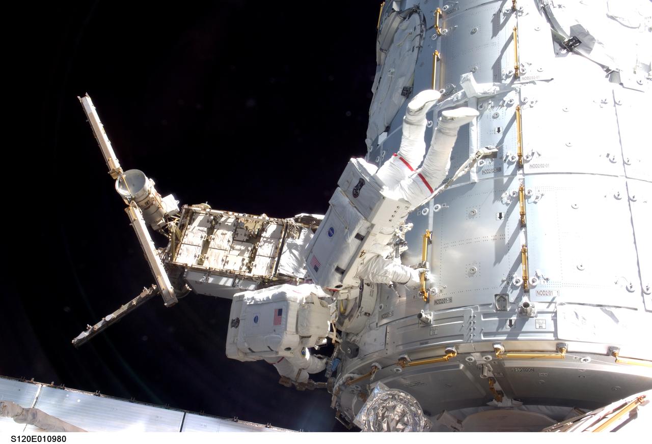S120-E-010980 (28 Oct. 2007) --- Astronauts Daniel Tani (left), Expedition 16 flight engineer, and Scott Parazynski, STS-120 mission specialist, participate in the second scheduled session of extravehicular activity (EVA) as construction continues on the International Space Station. During the 6-hour, 33-minute spacewalk Tani and Parazynski outfitted the Harmony module, mated the power and data grapple fixture and reconfigured connectors on the starboard 1 (S1) truss that will allow the radiator on S1 to be deployed from the ground later. Also the spacewalkers worked in tandem to disconnect cables from the P6 truss, allowing it to be removed from the Z1 truss. Tani also visually inspected the station's starboard Solar Alpha Rotary Joint (SARJ) and gathered samples of "shavings" he found under the joint's multi-layer insulation covers.