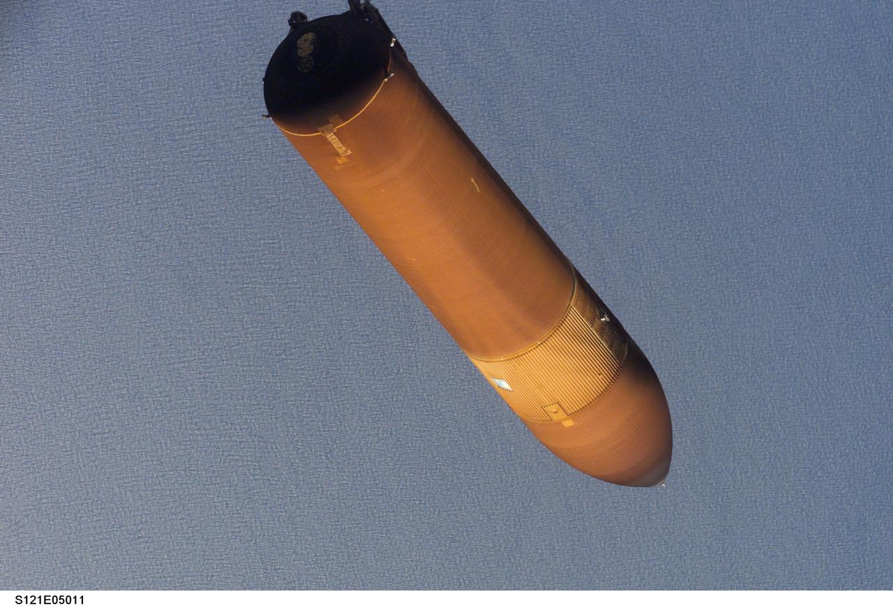 STS121-E-05011 (4 July 2006)-- This picture of the STS-121 external tank was taken with a digital still camera by an astronaut only seconds after separation from the Space Shuttle Discovery on launch day. Engineers, managers and flight controllers have carefully studied this image and other frames from this series as well as a number of pictures showing the falling ET as photographed from umbilical well cameras.