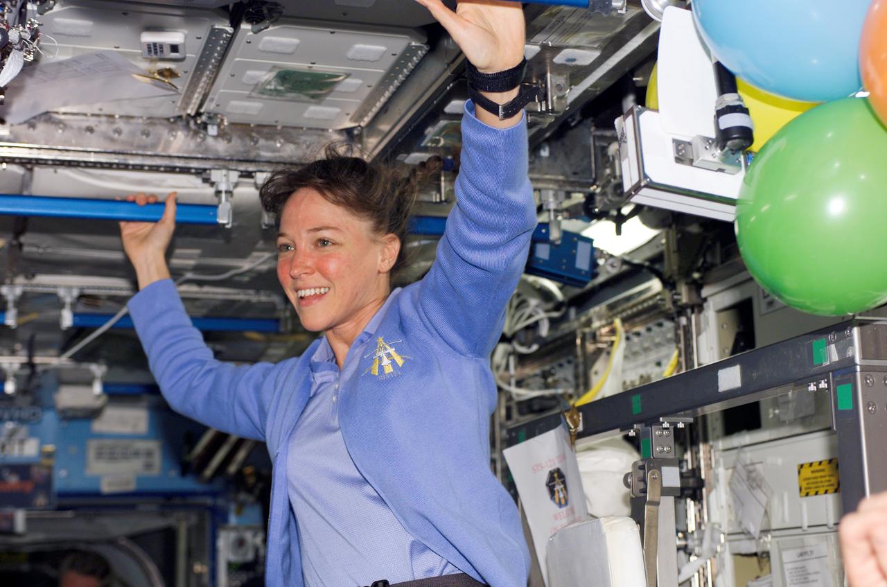 S121-E-05881 (6 July 2006) --- Astronaut Lisa M. Nowak, STS-121 mission specialist, smiles at a crewmate in the Destiny laboratory of the International Space Station.