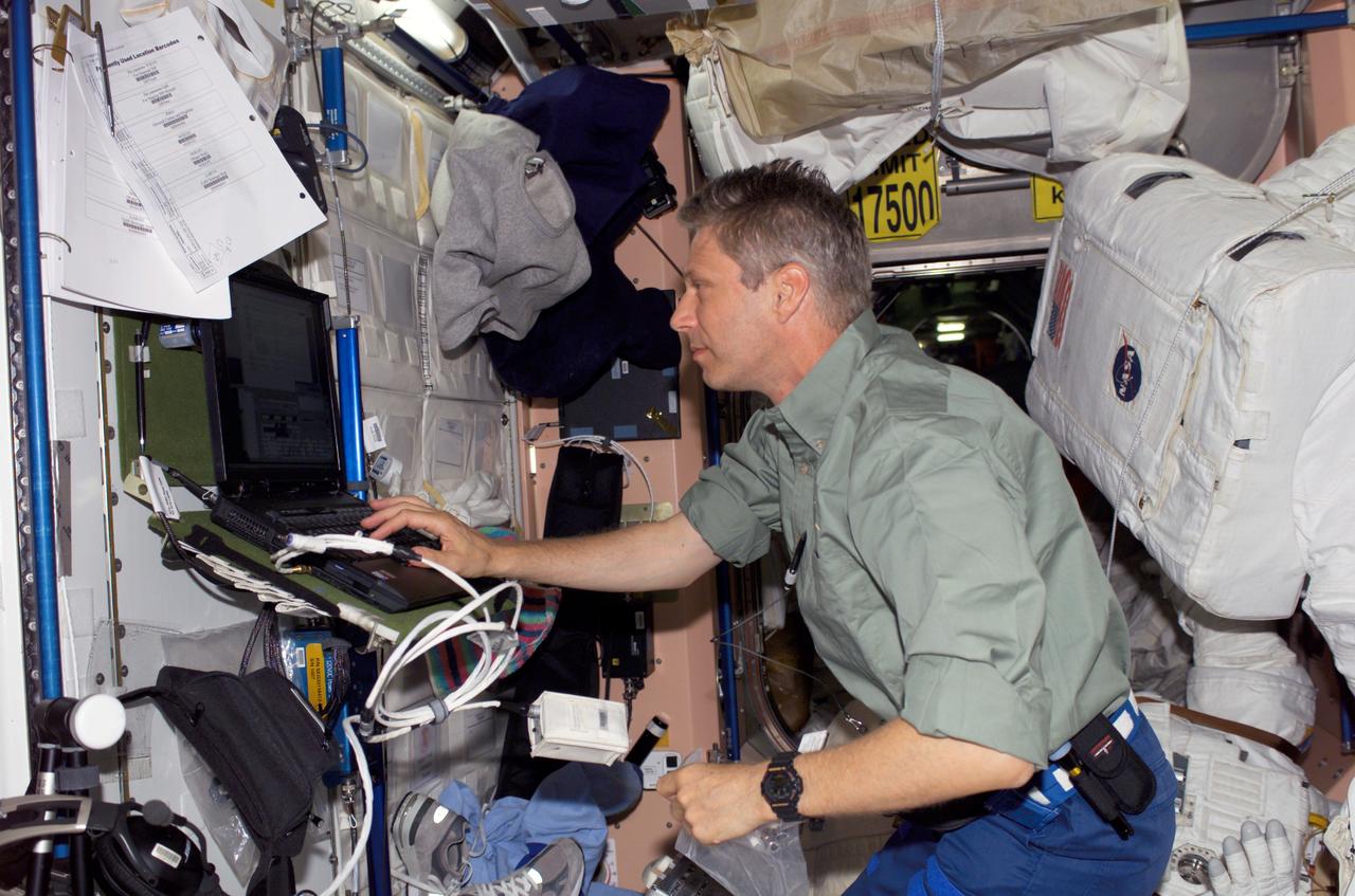 S121-E-05904 (7 July 2006) --- European Space Agency (ESA) astronaut Thomas Reiter of Germany uses a computer in the Unity node of the International Space Station. Upon delivery by the STS-121 Space Shuttle Discovery, Reiter joined the Expedition 13 crew as a flight enginee