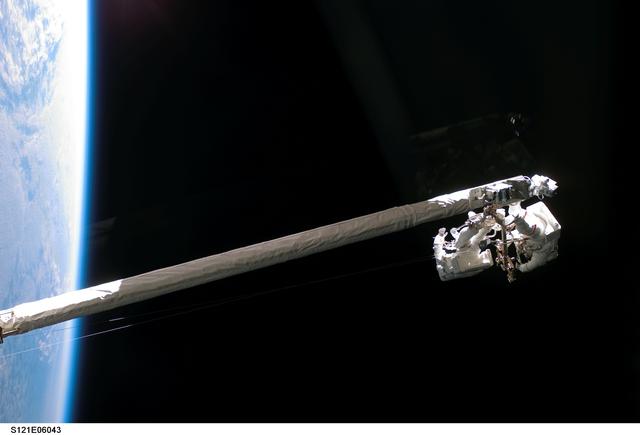 NASA image: Fossum and Sellers on the OBSS during EVA1 on STS-121 / Expedition 13 joint operations