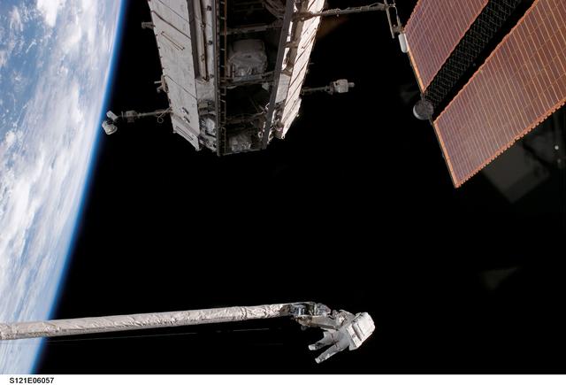 NASA image: Fossum and Sellers on the OBSS during EVA1 on STS-121 / Expedition 13 joint operations