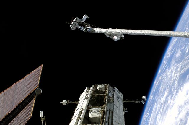 NASA image: Fossum and Sellers on the OBSS during EVA1 on STS-121 / Expedition 13 joint operations