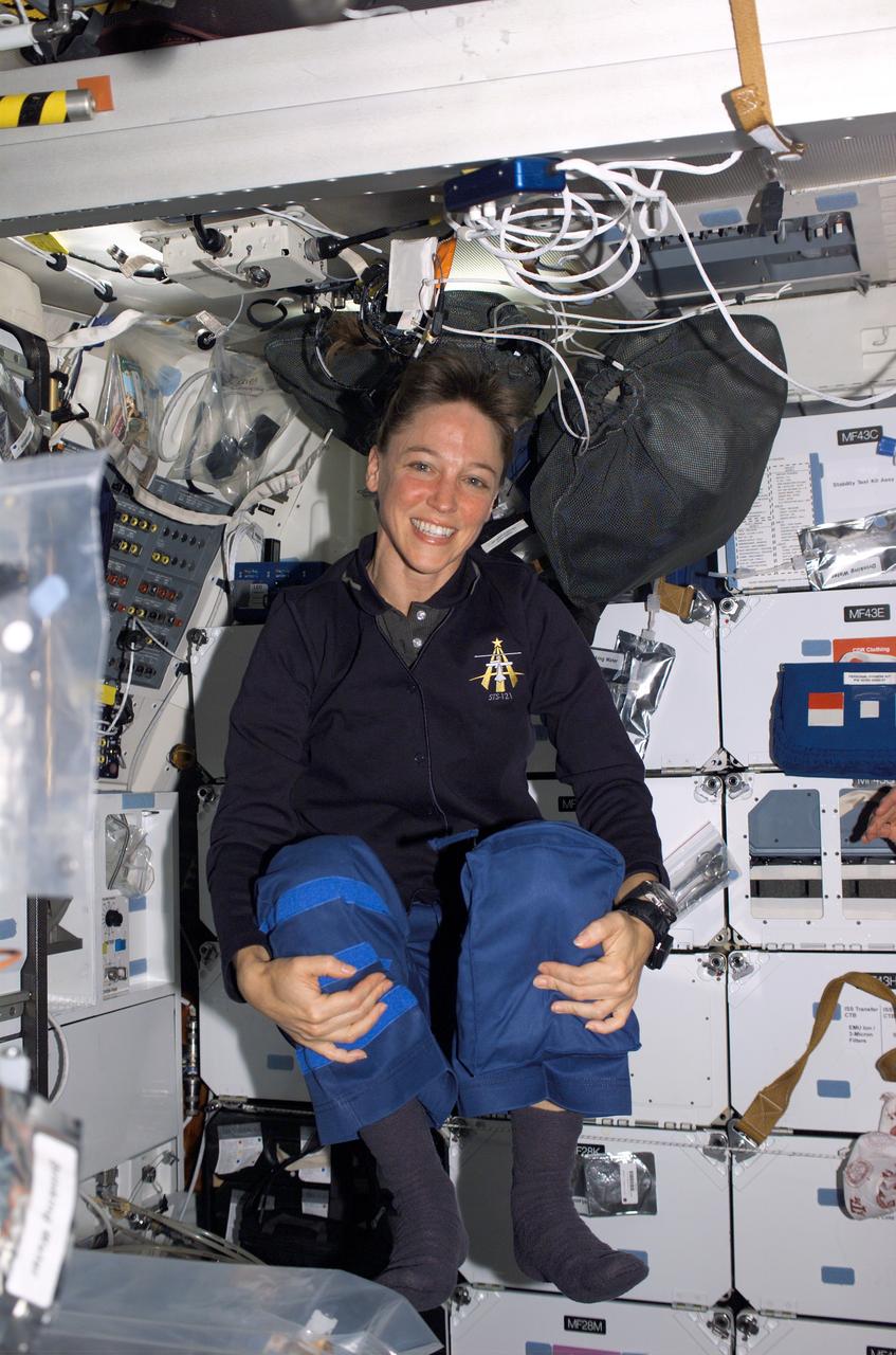 S121-E-06142 (8 July 2006) --- Astronaut Lisa M. Nowak, STS-121 mission specialist, floats on the middeck of the Space Shuttle Discovery while docked with the International Space Station.