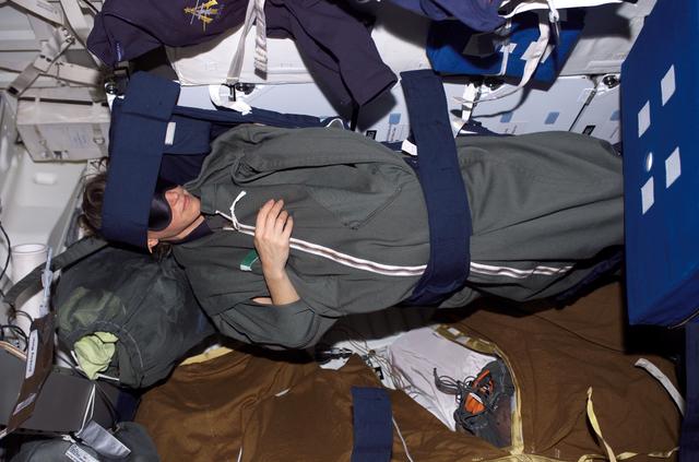 NASA image: Nowak in sleeping bag on the MDK during STS-121 / Expedition 13 joint operations
