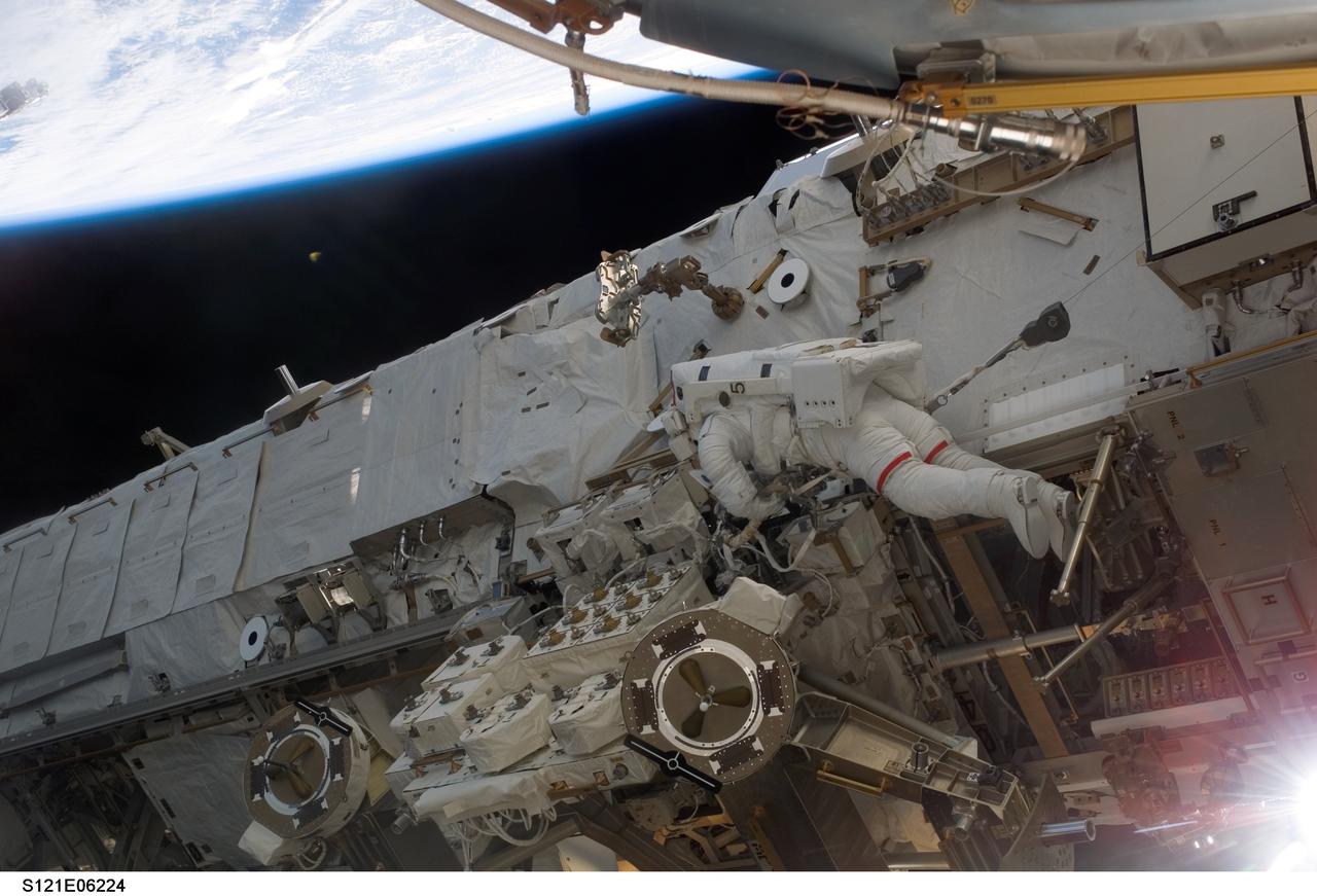 S121-E-06224 (10 July 2006) --- Astronaut Piers J. Sellers, STS-121 mission specialist, participates in the mission's second session of extravehicular activity (EVA). During today's six-hour 47-minute spacewalk, Sellers and astronaut Michael E. Fossum (out of frame), mission specialist, restored the International Space Station's Mobile Transporter rail car to full operation and delivered a spare pump module for the station's cooling system.