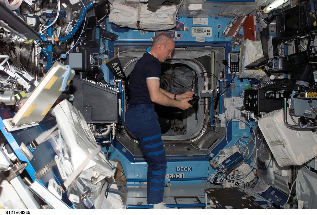 Williams with camera flash in the U.S. Lab during STS-121 / Expedition 13 joint operations