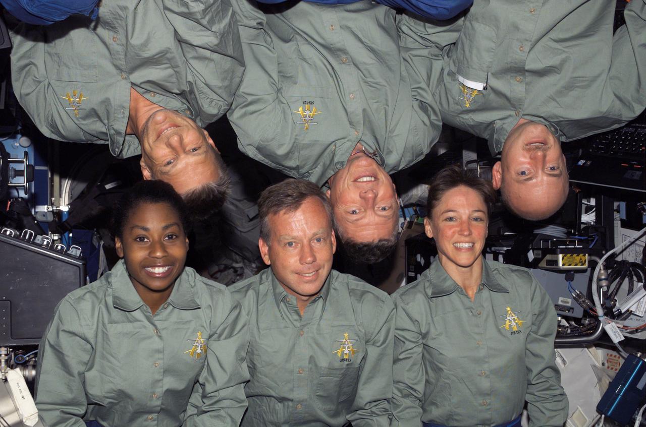 S121-E-06248 (9 July 2006) --- The STS-121 crewmembers gather for an in-flight crew photo in the Destiny laboratory of the International Space Station. From the left (bottom) are astronauts Stephanie D. Wilson, mission specialist; Steven W. Lindsey, commander; and Lisa M. Nowak, mission specialist. From the left (top) are astronauts Piers J. Sellers, Michael E. Fossum, both mission specialists; and Mark E. Kelly, pilot.