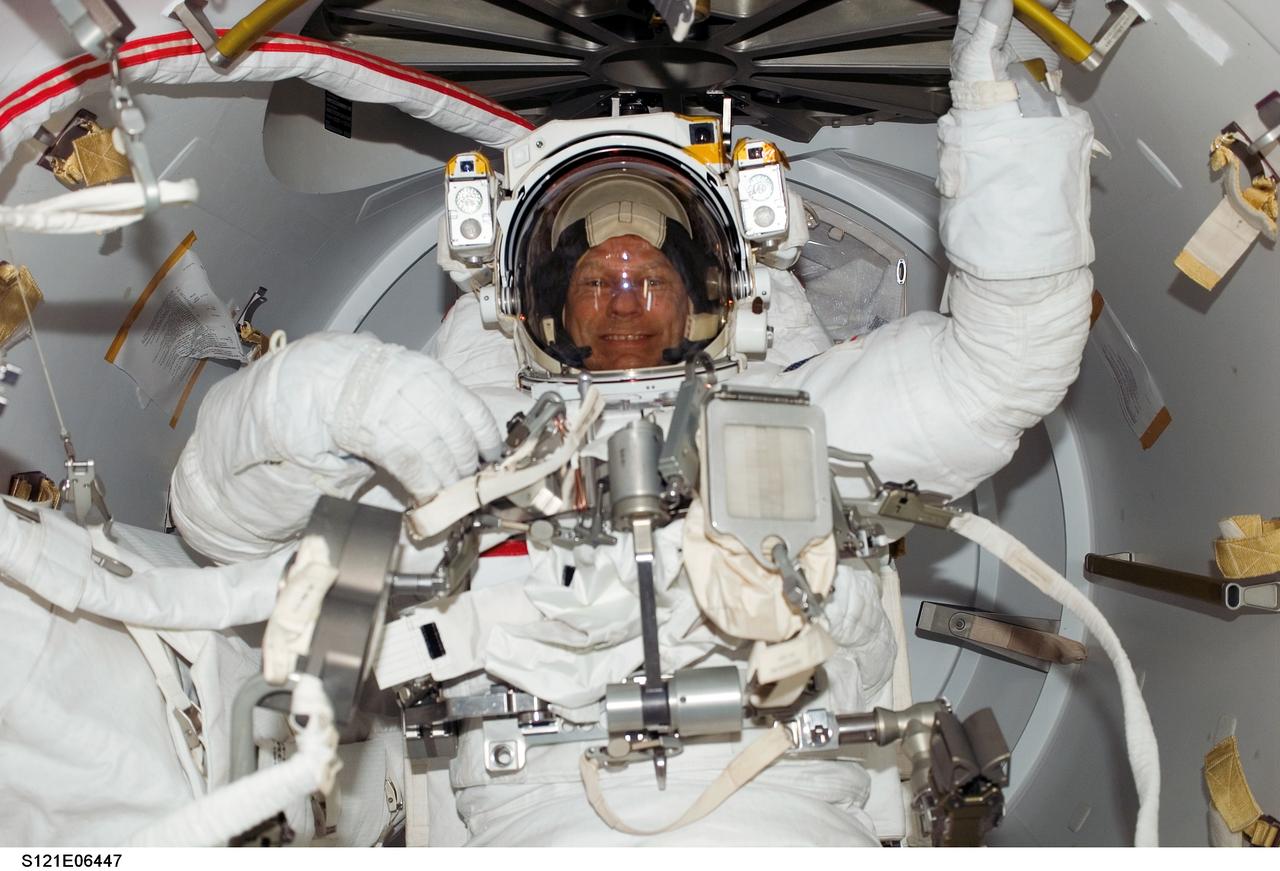 S121-E-06447 (12 July 2006) --- Astronaut Piers J. Sellers, STS-121 mission specialist, attired in his Extravehicular Mobility Unit (EMU) spacesuit, awaits the start of the mission's third session of extravehicular activity (EVA) in the Quest Airlock of the International Space Station.