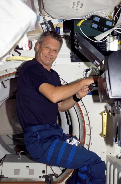 NASA image: Seller types at a computer during post sleep activities on STS-121 / Expedition 13 joint operations