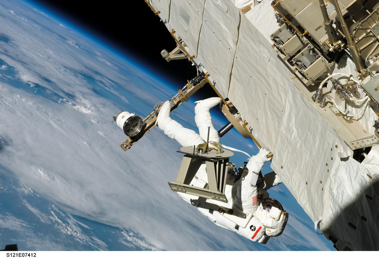 S121-E-07412 (12 July 2006) --- Astronaut Piers J. Sellers, STS-121 mission specialist, translates along a truss on the International Space Station during the mission's third and final session of extravehicular activity (EVA) while Space Shuttle Discovery was docked with the station.