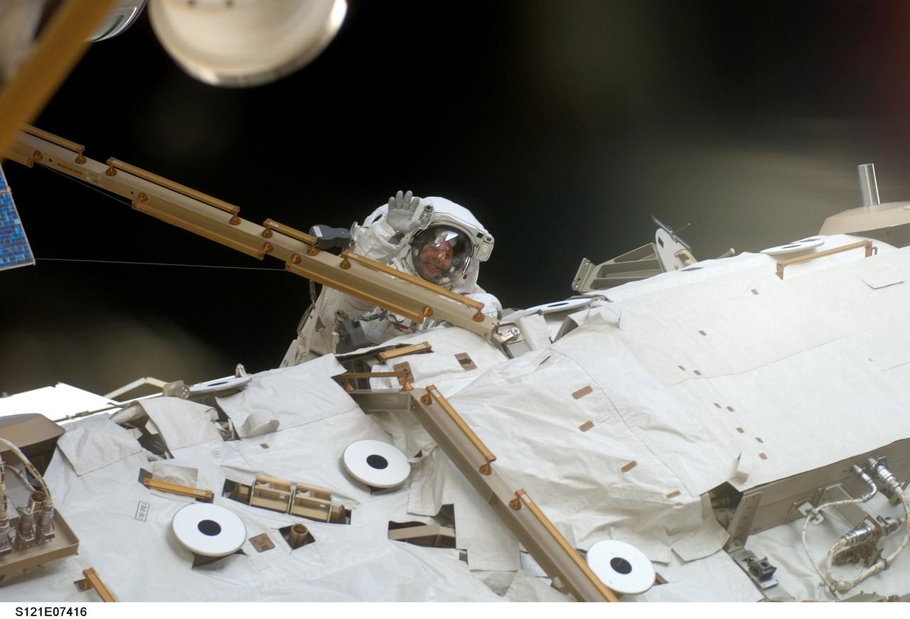 S121-E-07416 (12 July 2006) --- Astronaut Michael E. Fossum, STS-121 mission specialist, translates along a truss on the International Space Station during the mission's third and final session of extravehicular activity (EVA) while Space Shuttle Discovery was docked with the station.