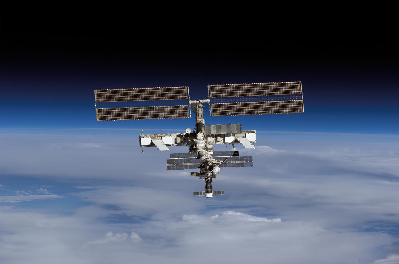 S121-E-07577 (15 July 2006) --- Backdropped by the blackness of space and Earth's horizon, the International Space Station moves away from Space Shuttle Discovery. Earlier the STS-121 and Expedition 13 crews concluded almost nine days of cooperative work onboard the shuttle and station. Undocking of the two spacecraft occurred at 5:08 a.m. (CDT) on July 15, 2006.