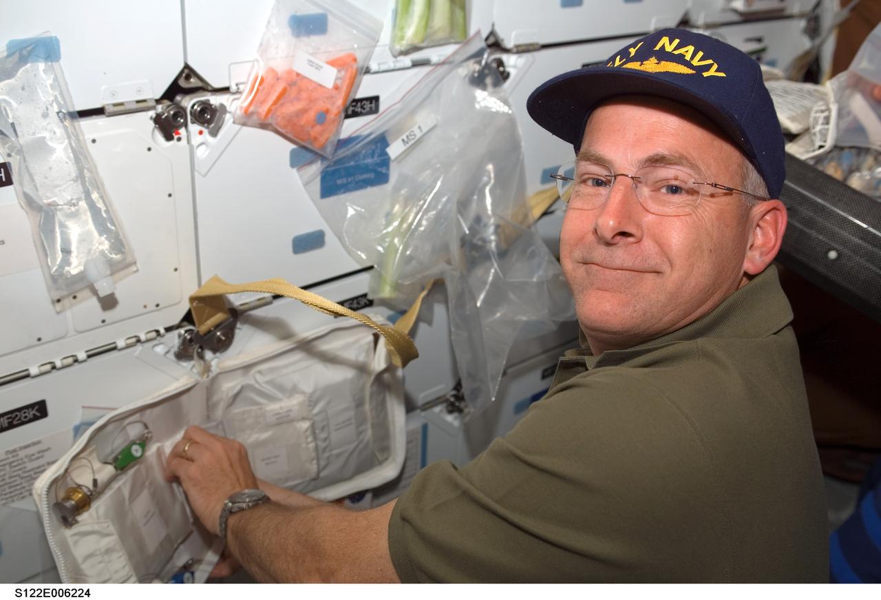S122-E-006224 (8 Feb. 2008) --- Astronaut Alan Poindexter, STS-122 pilot, works on the middeck of Space Shuttle Atlantis during flight day two activities.