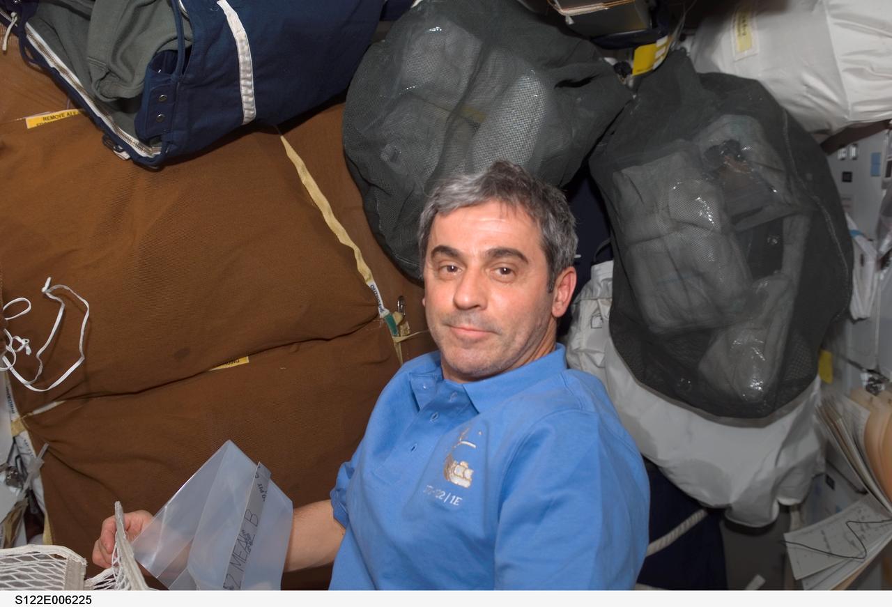 S122-E-006225 (8 Feb. 2008) --- European Space Agency (ESA) astronaut Leopold Eyharts, STS-122 mission specialist, pauses for a photo while working on the middeck of Space Shuttle Atlantis during flight day two activities. After docking with the International Space Station, Eyharts will join Expedition 16 in progress to serve as a flight engineer.