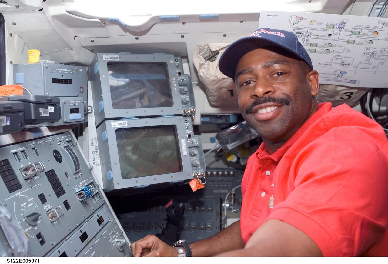 S122-E-006863 (8 Feb. 2008) --- Astronaut Leland Melvin, STS-122 mission specialist, takes a moment for a photo while working on the aft flight deck of Space Shuttle Atlantis during flight day two activities.