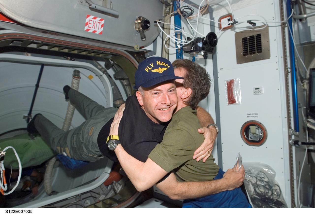 S122-E-007035 (9 Feb. 2008) --- Astronaut Alan Poindexter, STS-122 pilot, greets astronaut Peggy Whitson, Expedition 16 commander, as the Atlantis crew joined the ISS crewmembers onboard the orbiting outpost.
