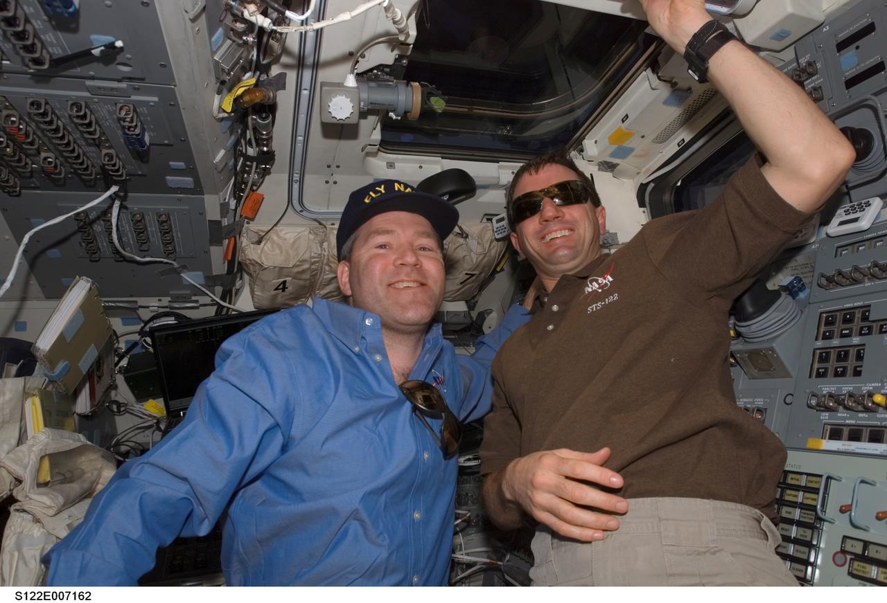 S122-E-007162 (9 Feb. 2008) --- Astronauts Steve Frick (left) and Rex Walheim, STS-122 commander and mission specialist, respectively, take a moment for a photo on the aft flight deck of Space Shuttle Atlantis during flight day three activities.