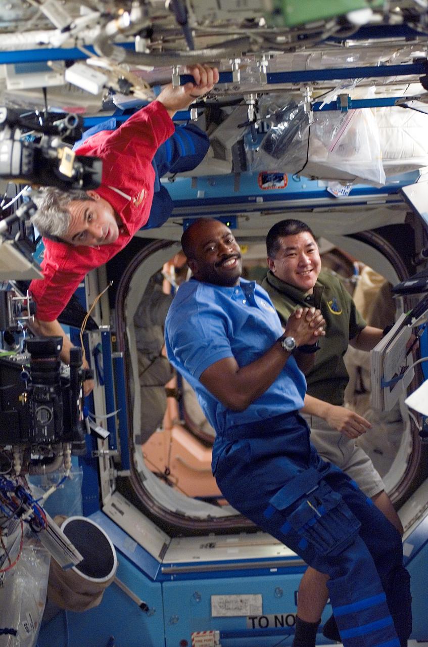 S122-E-007776 (11 Feb. 2008) --- European Space Agency (ESA) astronaut Leopold Eyharts (left), Expedition 16 flight engineer; along with NASA astronauts Leland Melvin and Daniel Tani (background), both STS-122 mission specialists, are pictured while working in the Destiny laboratory of the International Space Station.