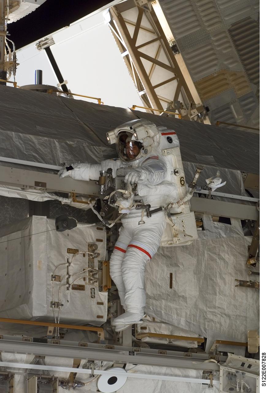 S122-E-007828 (11 Feb. 2008) --- Astronaut Rex Walheim, STS-122 mission specialist, participates in the first scheduled session of extravehicular activity (EVA) as construction and maintenance continue on the International Space Station. During the almost eight-hour spacewalk, Walheim and astronaut Stanley Love (out of frame), mission specialist, installed a grapple fixture on the Columbus laboratory and prepared electrical and data connections on the module while it rested inside Space Shuttle Atlantis' payload bay. The crewmembers also began work to replace a large nitrogen tank used for pressurizing the station's ammonia cooling system.