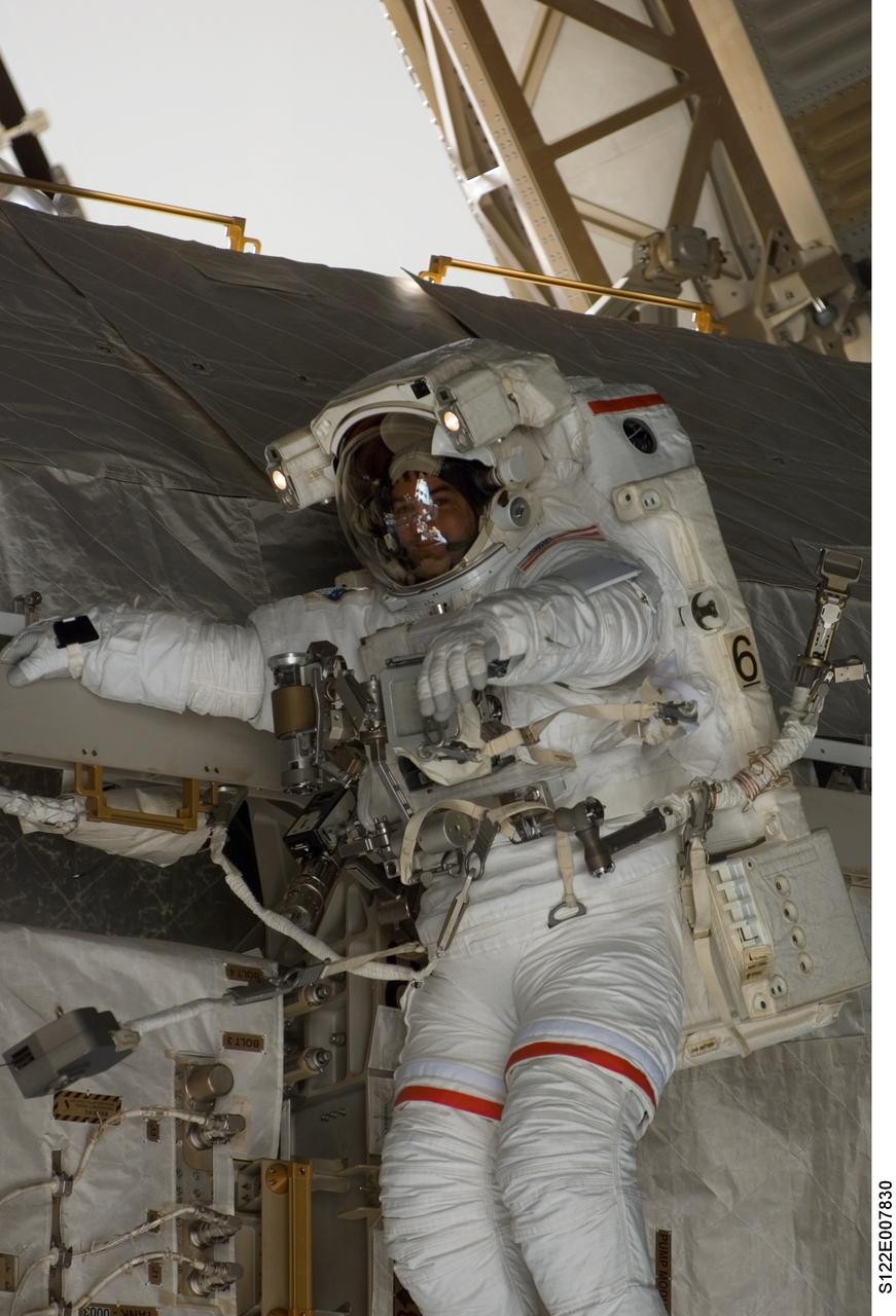 S122-E-007830 (11 Feb. 2008) --- Astronaut Rex Walheim, STS-122 mission specialist, participates in the first scheduled session of extravehicular activity (EVA) as construction and maintenance continue on the International Space Station. During the almost eight-hour spacewalk, Walheim and astronaut Stanley Love (out of frame), mission specialist, installed a grapple fixture on the Columbus laboratory and prepared electrical and data connections on the module while it rested inside Space Shuttle Atlantis' payload bay. The crewmembers also began work to replace a large nitrogen tank used for pressurizing the station's ammonia cooling system.