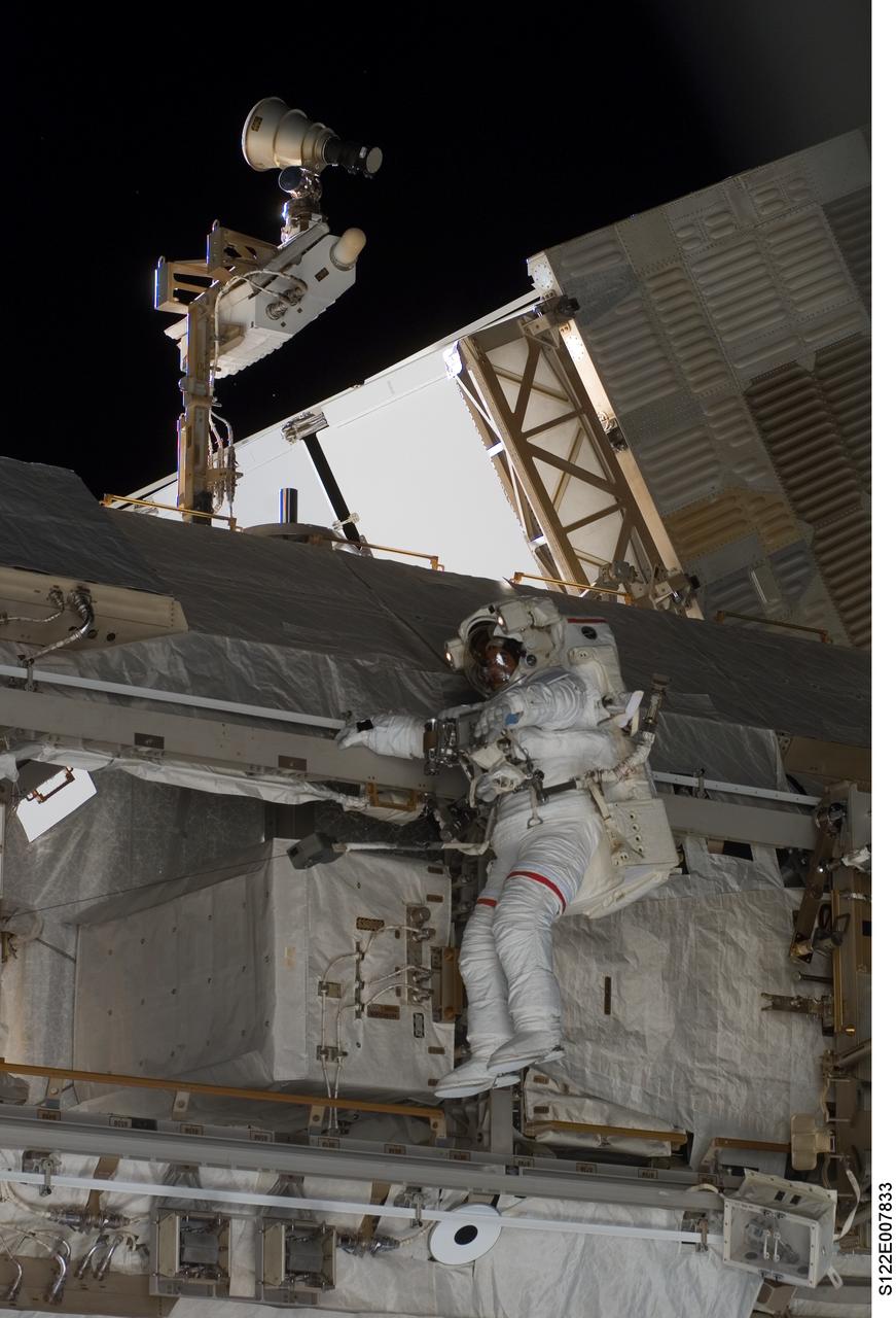 S122-E-007833 (11 Feb. 2008) --- Astronaut Rex Walheim, STS-122 mission specialist, participates in the first scheduled session of extravehicular activity (EVA) as construction and maintenance continue on the International Space Station. During the almost eight-hour spacewalk, Walheim and astronaut Stanley Love (out of frame), mission specialist, installed a grapple fixture on the Columbus laboratory and prepared electrical and data connections on the module while it rested inside Space Shuttle Atlantis' payload bay. The crewmembers also began work to replace a large nitrogen tank used for pressurizing the station's ammonia cooling system.