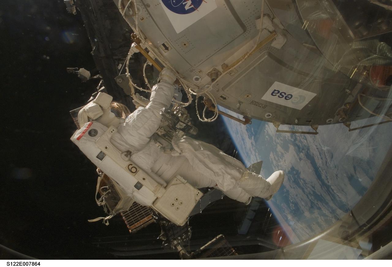 S122-E-007864 (11 Feb. 2008) --- Astronaut Rex Walheim, STS-122 mission specialist, participates in the first scheduled session of extravehicular activity (EVA) as construction and maintenance continue on the International Space Station. During the almost eight-hour spacewalk, Walheim and astronaut Stanley Love (out of frame), mission specialist, installed a grapple fixture on the Columbus laboratory and prepared electrical and data connections on the module while it rested inside Space Shuttle Atlantis' payload bay. The crewmembers also began work to replace a large nitrogen tank used for pressurizing the station's ammonia cooling system.