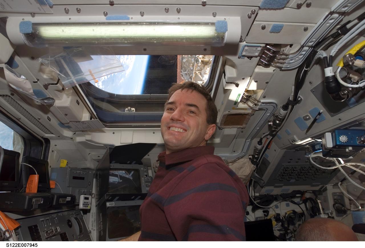S122-E-007945 (12 Feb.2008) --- Astronaut Rex Walheim, STS-122 mission specialist, is pictured on the aft flight deck of Space Shuttle Atlantis during flight day six activities while docked with the International Space Station.