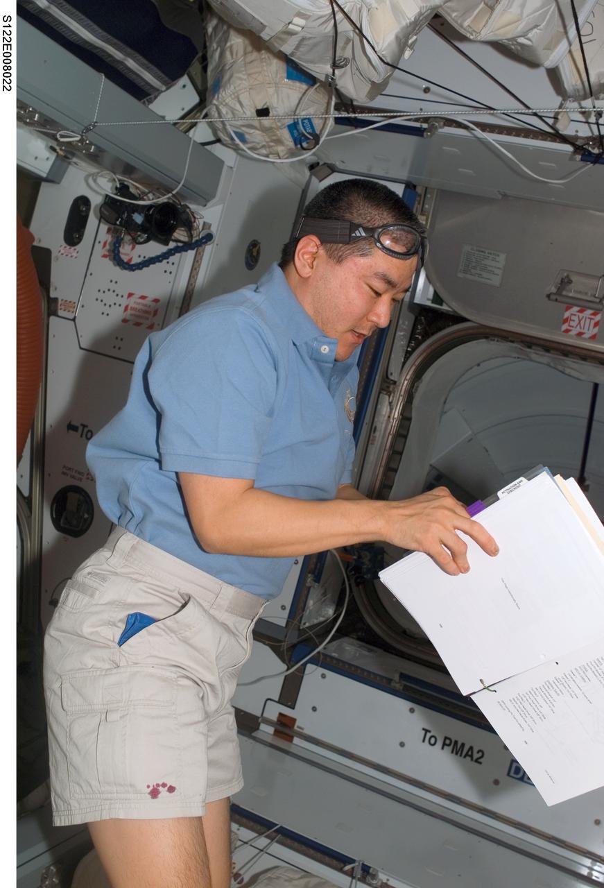 S122-E-008022 (12 Feb. 2008) --- Astronaut Daniel Tani, STS-122 mission specialist, works in the Harmony module of the International Space Station while Space Shuttle Atlantis is docked with the station.