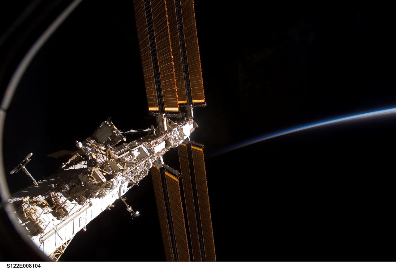 S122-E-008104 (13 Feb. 2008) --- A section of the International Space Station is featured in this image photographed by a STS-122 crewmember on Space Shuttle Atlantis while docked with the station. The blackness of space and Earth's airglow provide the backdrop for the scene.
