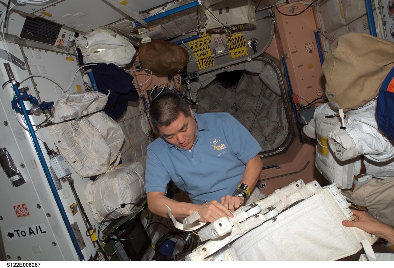 S122-E-008287 (13 Feb. 2008) --- Astronaut Daniel Tani, STS-122 mission specialist, works in the Unity node of the International Space Station while Space Shuttle Atlantis is docked with the station.