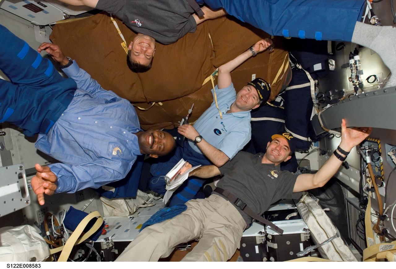 S122-E-008583 (14 Feb. 2008) --- Astronauts Steve Frick (second right), STS-122 commander; Leland Melvin (left), Stanley Love (top) and Rex Walheim, all mission specialists, take a moment during flight day eight activities for a photo on the middeck of Space Shuttle Atlantis while docked with the International Space Station.