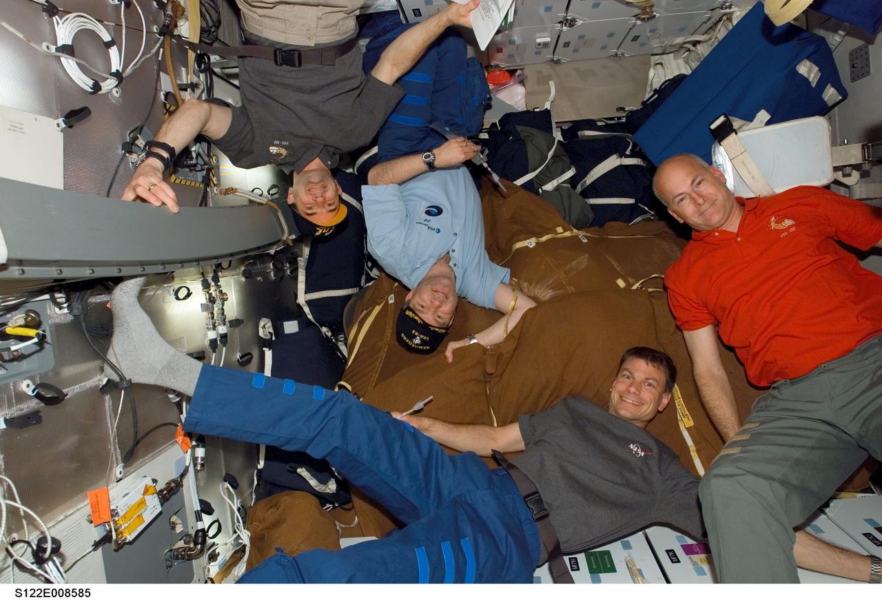 S122-E-008585 (14 Feb. 2008) --- Astronauts Rex Walheim (left), STS-122 mission specialist; Steve Frick, commander; Stanley Love, mission specialist; and Alan Poindexter, pilot, take a moment during flight day eight activities for a photo on the middeck of Space Shuttle Atlantis while docked with the International Space Station.