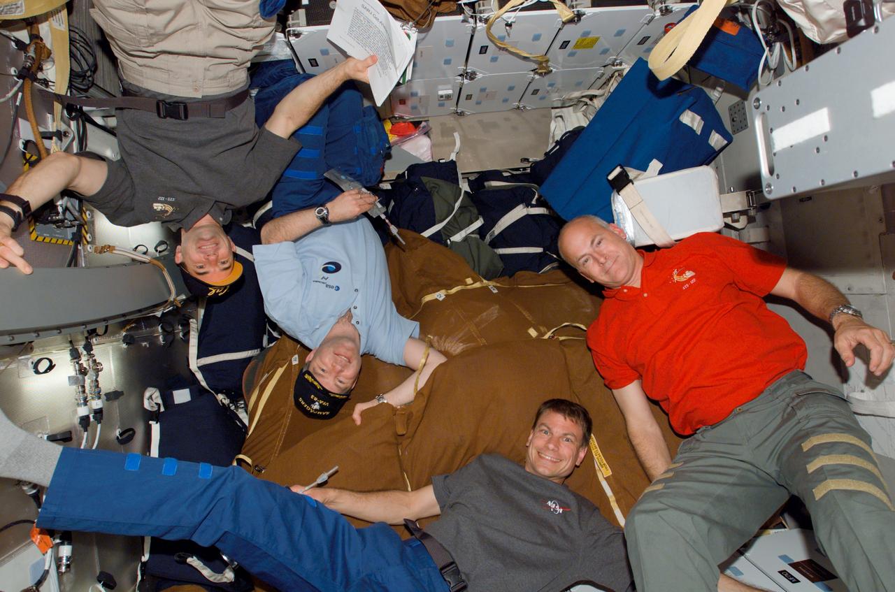 S122-E-008586 (14 Feb. 2008) --- Astronauts Rex Walheim (left), STS-122 mission specialist; Steve Frick, commander; Stanley Love, mission specialist; and Alan Poindexter, pilot, take a moment during flight day eight activities for a photo on the middeck of Space Shuttle Atlantis while docked with the International Space Station.