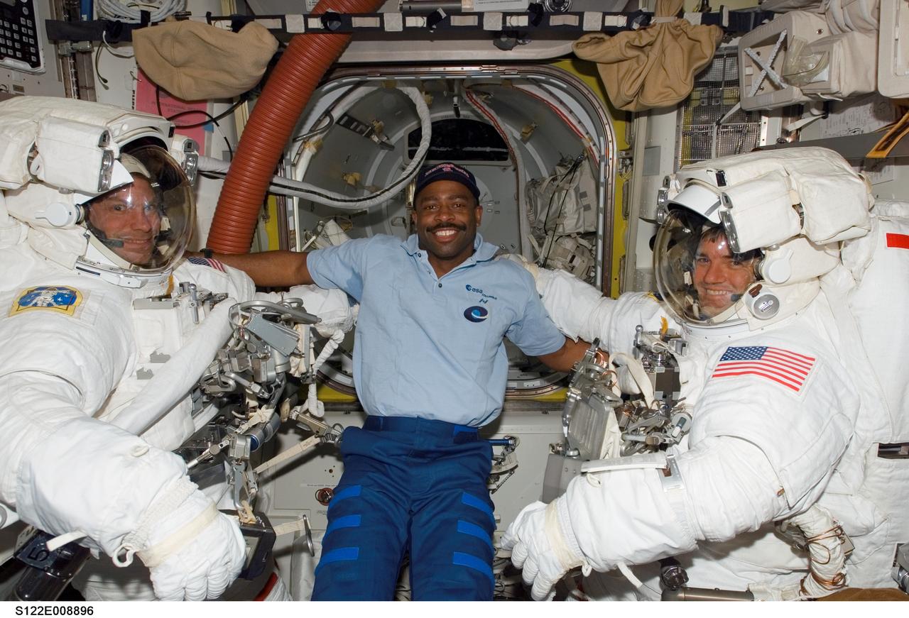 S122-E-008896 (15 Feb. 2008) --- Astronaut Leland Melvin, STS-122 mission specialist, lends his intravehicular support to the two STS-122 mission specialists assigned to the mission's final spacewalk to perform work on the International Space Station. Equipped with their extravehicular mobility units (EMU) and other gear and just about ready to egress the station and begin the day's external tasks are astronauts Stanley Love (left) and Rex Walheim.
