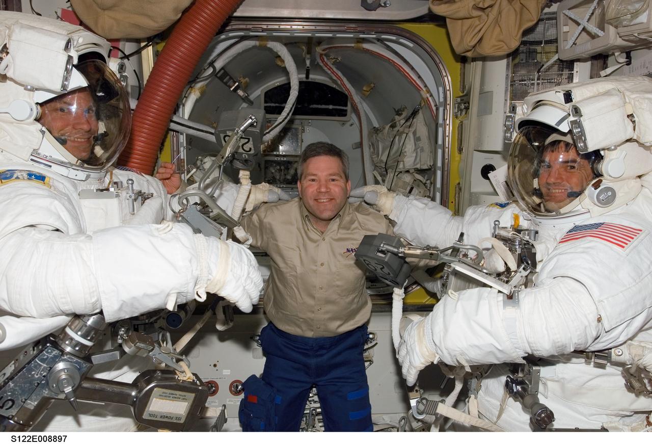 S122-E-008897 (15 Feb. 2008) --- Astronaut Steve Frick, STS-122 commander, shares his enthusiasm and support with the two STS-122 mission specialists assigned to the mission's final spacewalk to perform work on the International Space Station. Equipped with their extravehicular mobility units (EMU) and other gear and just about ready to egress the station and begin the day's external tasks are astronauts Stanley Love (left) and Rex Walheim.