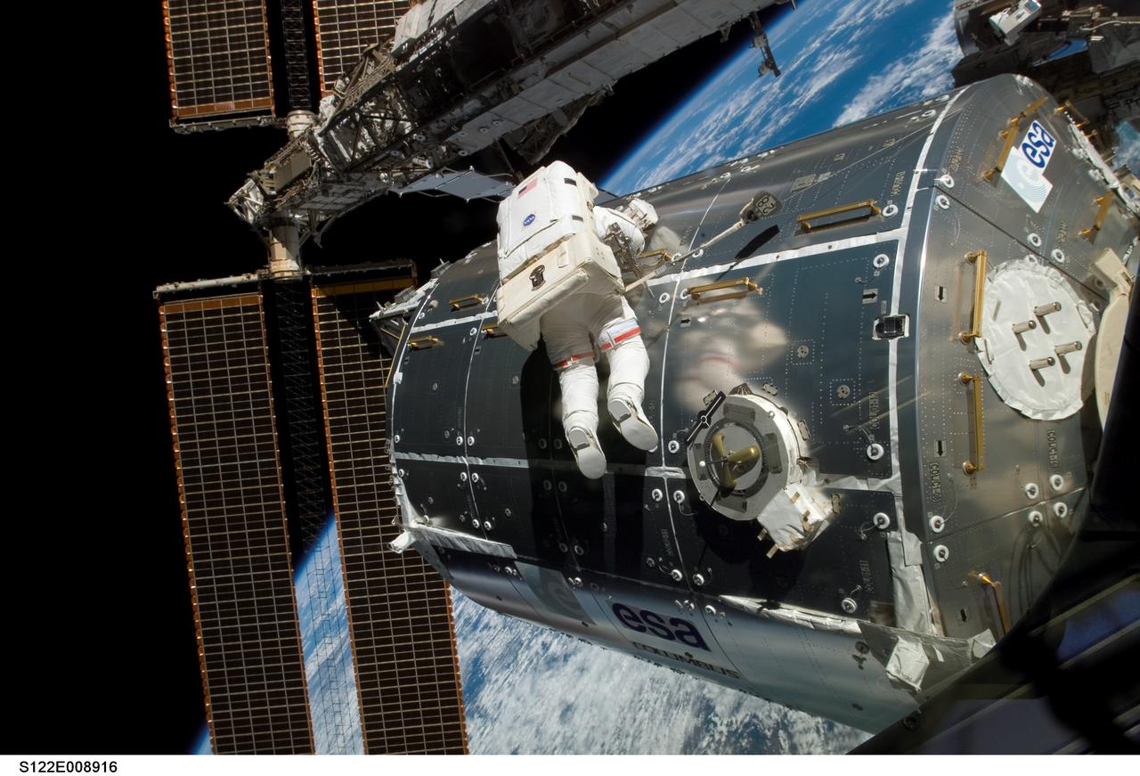 S122-E-008916 (15 Feb. 2008) --- Astronaut Rex Walheim, mission specialist, performs work on the outside of the Columbus laboratory, the newest piece of hardware on the International Space Station. Astronaut Stanley Love (out of frame), mission specialist, shared this final period of STS-122 extravehicular activity with Walheim.